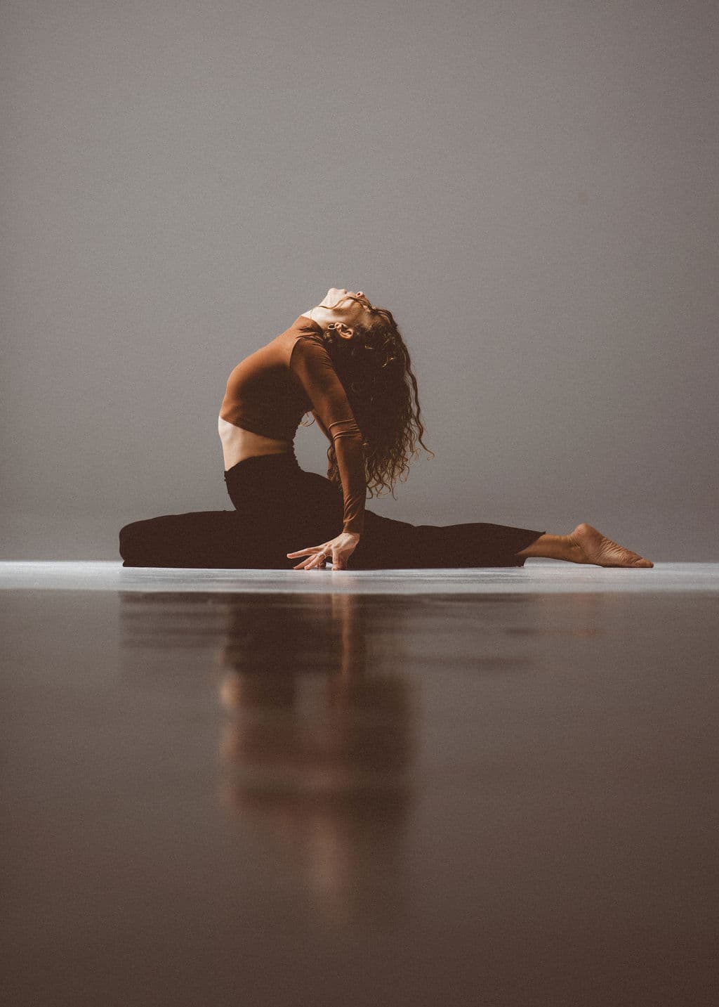 Lucia in a grounded backbend, reaching toward the light
